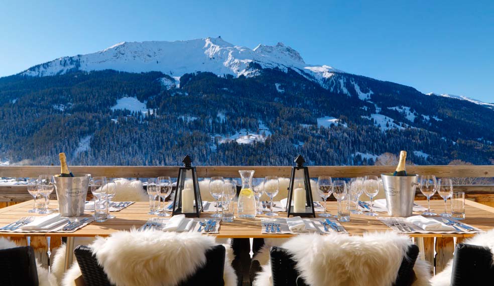 Al fresco dining on the terrace at a luxury chalet in the Alps