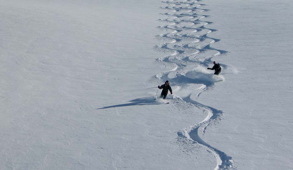 Skiers tracing patterns in the snow